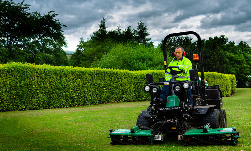 contractor using Ransomes machine to cut grass